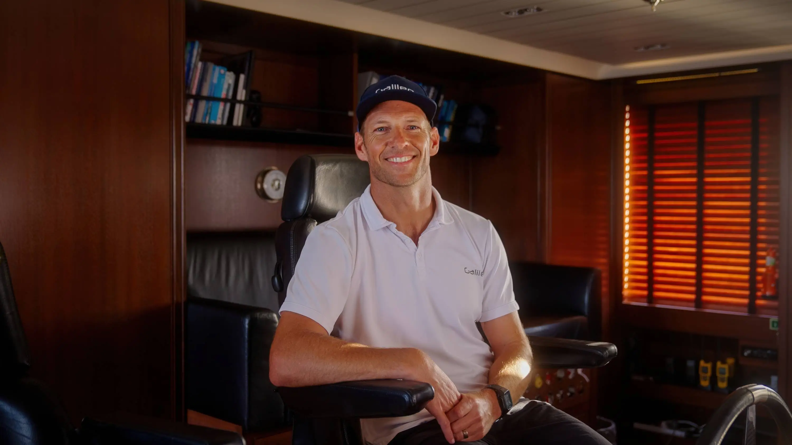 Smiling man yacht interior relaxing atmosphere
